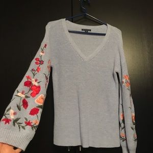 blue sweater with floral sleeves